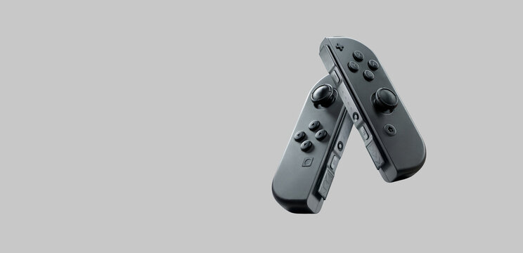 2 joy con controls of the nintendo switch console floating in the air on a white background: Sonora, Mexico - November 21, 2024