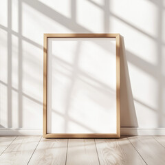 A wooden mock up poster frame set against the wall in a modern minimalist room