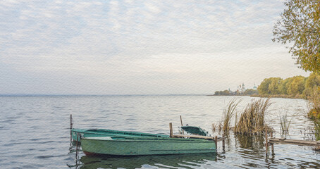 Obraz premium Small green boat is floating in the water near a shore