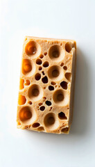 Close-up view of a slice of Swiss cheese featuring distinctive holes. Ideal for food-related content, cooking magazines, or dairy product promotions.
