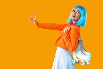 Beautiful young happy woman in blue wig with vintage roller skates on yellow background