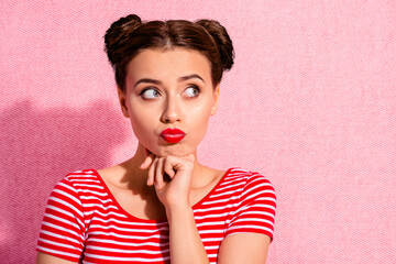 Close up photo beautiful she her lady pretty two buns pomade lips hold hand arm chin look up empty space ponder pensive contemplation wear casual striped red white t-shirt isolated pink background