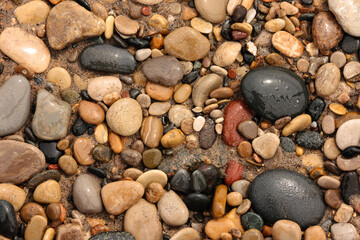 A natural grouping of stones on the beach at Kohler Andrae State Park, Sheboygan, Wisconsin, wet after rinsed by the Lake Michigan waves.