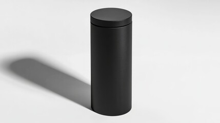A tall, cylindrical box with a matte black finish, standing upright on a clean white surface
