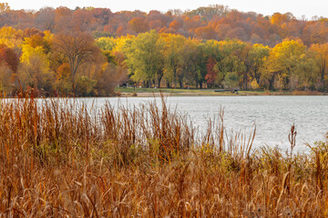 Looking back at the picnic area and beach within Pike Lake Unit, Kettle Moraine State Forest, Hartford, Wisconsin in late October, the hillside with muted color