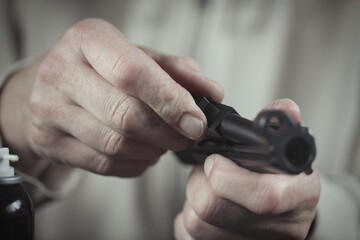 Obraz premium Man take care of semi automatic pistol handgun at home