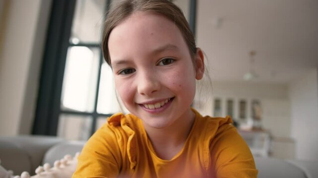 Mobile phone point of view happy Caucasian child glad schoolgirl at home touch display device little girl typing screen smiling kid daughter chatting online app playing virtual game addict POV webcam