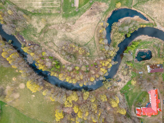 Aerial View of River and Red Roofed Building in Spring Landscape