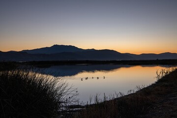 sunrise over the lake with orange and blue hues mixed in for a gorgeous image