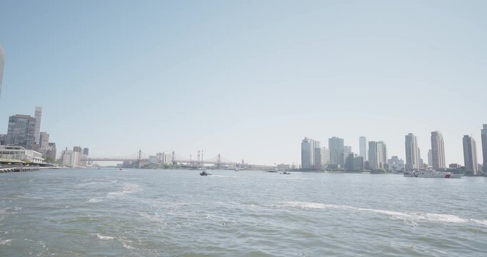 NYC Small Boat and Patrol Boat with Bridge and LIC Skyline in BG - 4K 48fps ProRes
