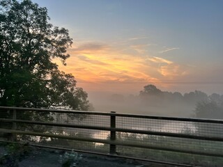 Obraz premium foggy sunrise over the river