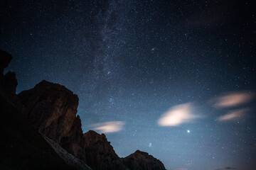 A beautiful starry night sky with a majestic mountain in the foreground