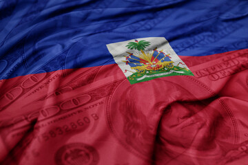 waving colorful flag of haiti on the dollar money background. finance concept.