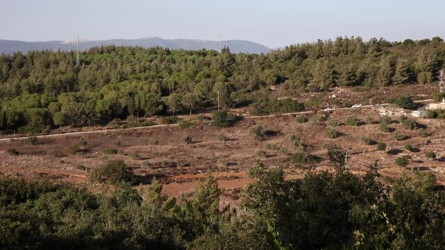 Far View of cars driving on the mountains road on the forset trees background