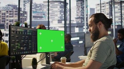 Man working with machine learning tech on green screen computer, advancing AI innovating autonomous...