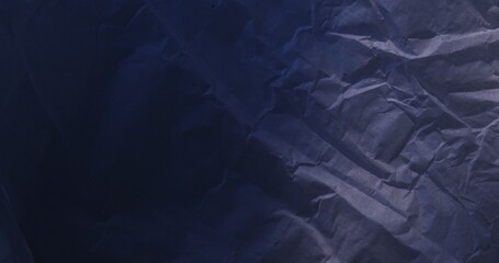Wrinkled paper texture with deep folds and shadows.