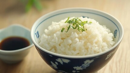 Steaming Bowl of White Rice Garnished with Fresh Herbs Resting on a Wooden Surface Alongside a Small Dish of Soy Sauce for a Flavorful Asian Culinary Experience