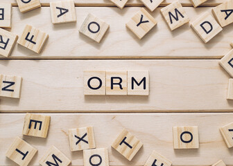 Wooden board with a bunch of wooden letters scattered around it