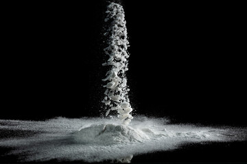 Baking soda powder explode in mid air. Powder of baking soda flying like explosion splashing, prepare to clean food vegetable as sodium bicarbonate carbonate, black background isolated