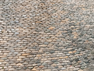 A stone wall with a pattern of small stones