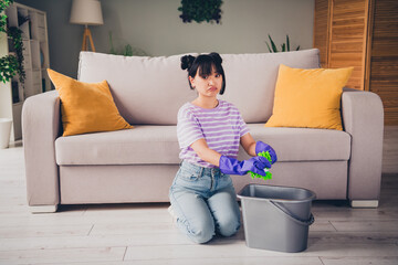 Photo of unhappy sad girl dressed t-shirt dislike washing floor indoors house apartment room