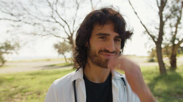 Charming Young Doctor with Long Hair Seduces a Woman Outside The Hospital