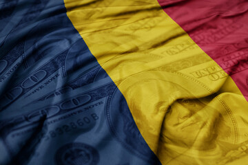 waving colorful flag of chad on the dollar money background. finance concept.