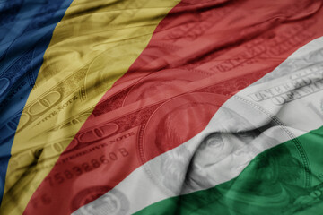 waving colorful flag of seychelles on the dollar money background. finance concept.