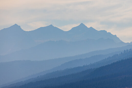 Jagged Montana Bitterroot Mountains looking blue and gray  layered in smoke and the summer heat