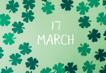 Green background with a bunch of shamrocks and the word March written in white