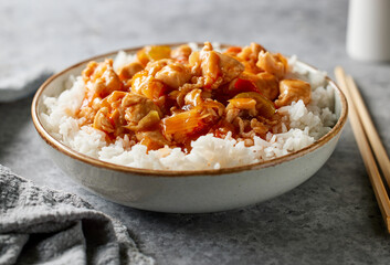 bowl of boiled rice with sweet and sour sauce