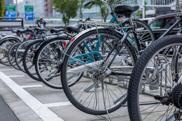 Bicycle parking in the city. View of the rear wheels. Ecological type of transport. Close-up.
