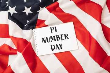 White sign with the word pi written on it is placed on top of a red