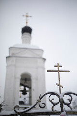 Orthodox Church on a winter day. Ancient bell tower. Religious building.
