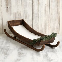 Rustic wooden sleigh filled with white faux snow and greenery, perfect for winter or Christmas photoshoots.