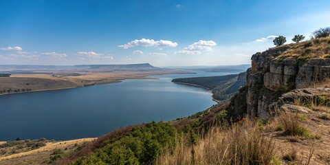 Unobstructed breathtaking panorama of a wide reservoir on the edge of the Northcliff cliffs gazing out at a vast expanse of blue with not a cloud in sight, landscape, , unobstructed