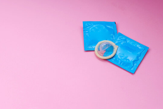 Top View of Condon With Wrapper Isolated on Pink Background