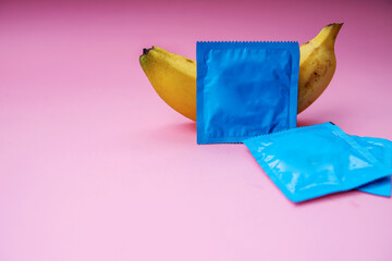 Yellow Banana With Condom Isolated on Pink Background