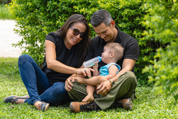 Photo of child with Down syndrome drinking milk with his parents
