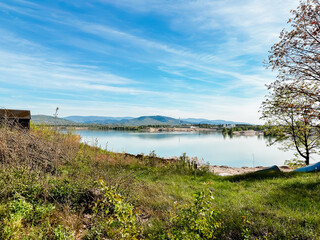 A beautiful lake with a small house in the background