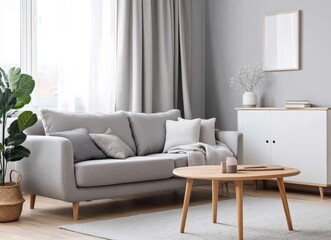 Minimalist living room with a grey sofa, wooden coffee table, and a large plant.