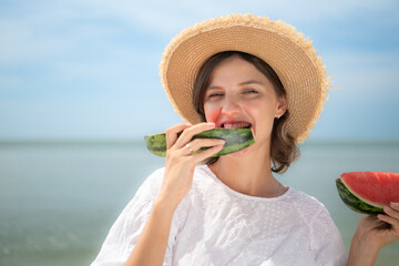 Portrait of young woman relaxing and eat water melon on the beach