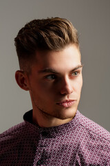 Portrait of the handsome man in shirt. Young guy model headshot. Male face. Young handsome man. Confident male model. Man looking proud. Closeup face of attractive man. Elegant guy.