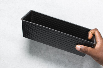 Overhead view of a Black loaf baking pan with patterns, top view of a cast iron loaf pan