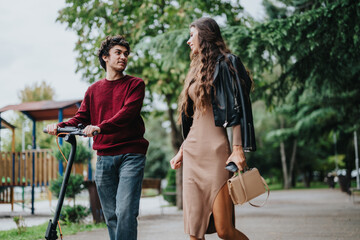 A young couple shares a joyful moment outdoors, with a man riding a scooter and a woman strolling beside him. The lush greenery creates a vibrant and relaxing atmosphere.