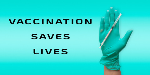 Hand holding a syringe with the words Vaccination saves lives