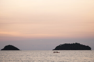 Sunset with seascape in foreground with large colourful sun