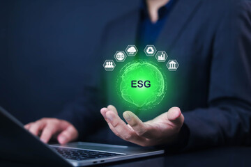 ESG Concepts on Environment, Natural environment, Businessman ues laptop and show icon on hand virtual, with analyze investment sustainability ESG icons and corporation development.