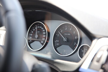 A close up of a car with the speedometer showing the speedometer.