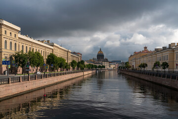 View of St. Isaac's Cathedral and the Moika River embankment on a sunny summer morning, St. Petersburg, Russia